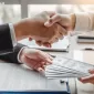 Corruption and Bribery ,Businessman shaking hands giving dollar bills corruption bribery to business manager to deal contract
